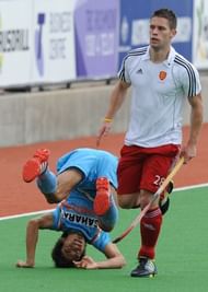 Mark Gleghorne of England runs past Kothajit Singh of India